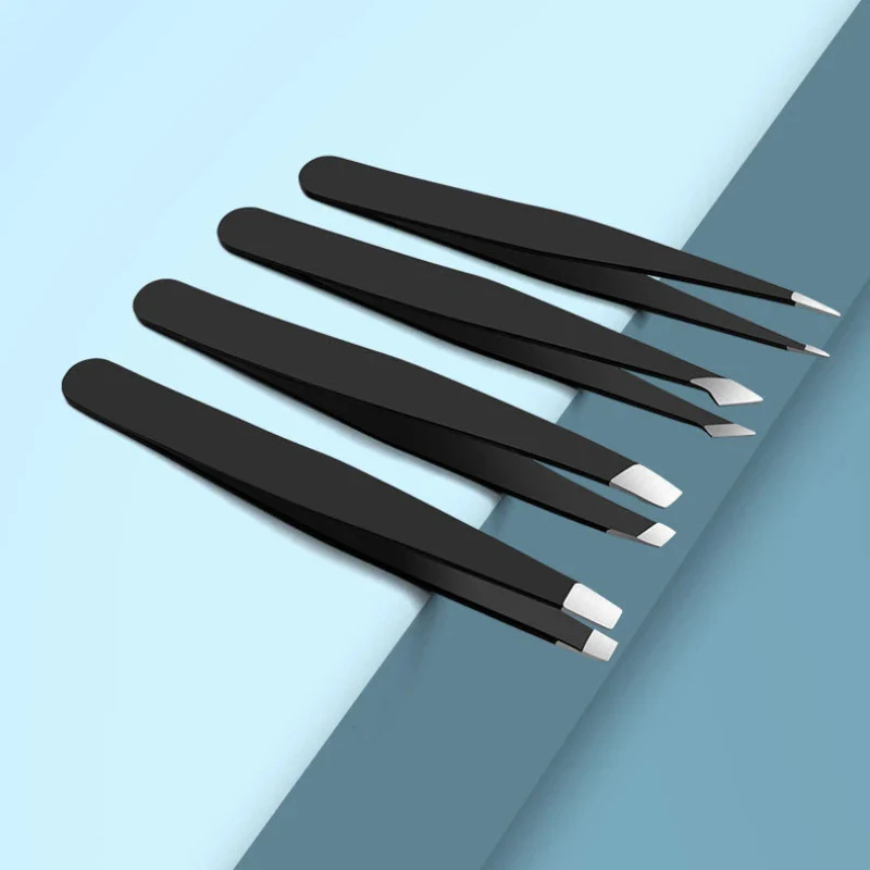 Four black tweezers arranged on blue